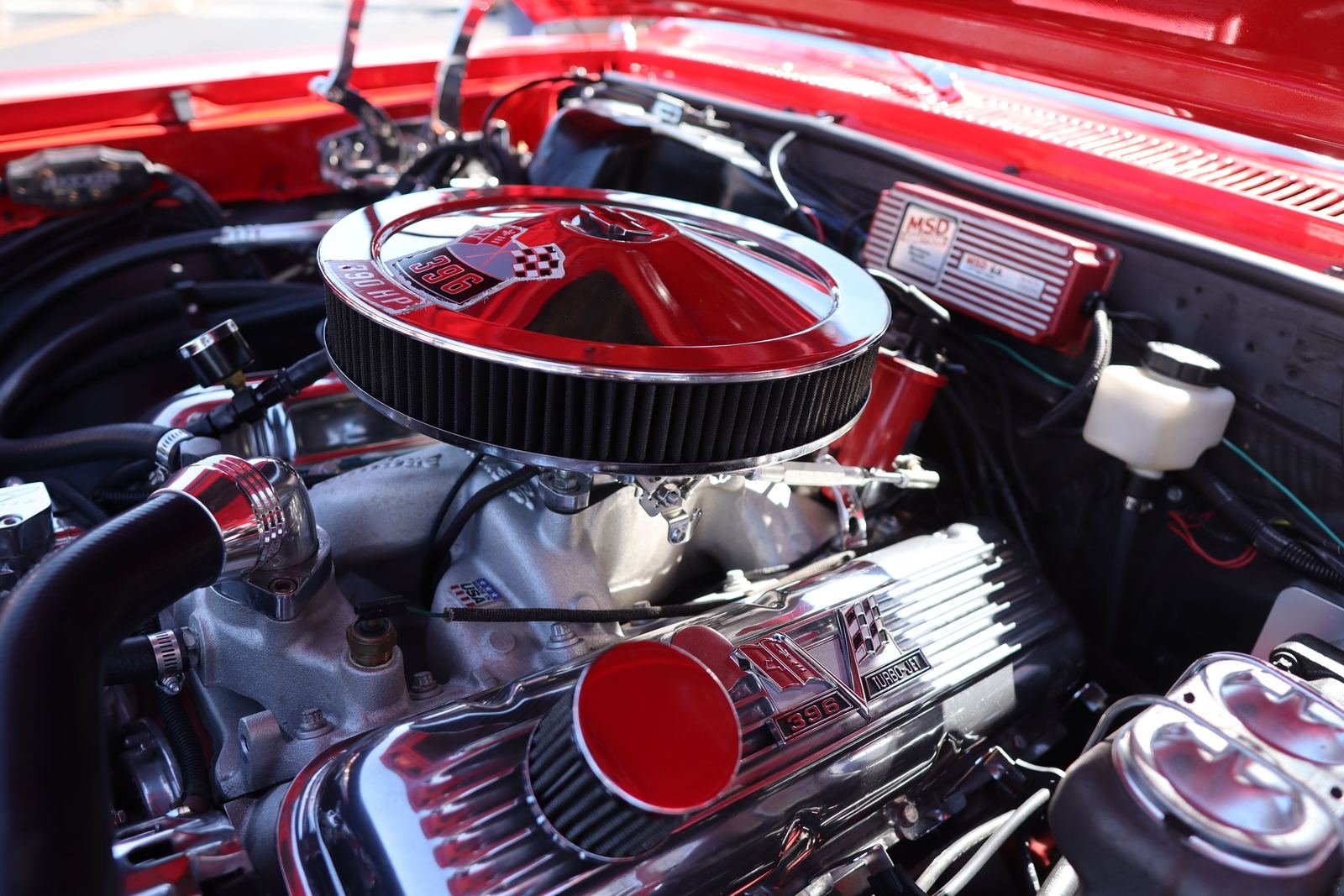 A red classic V8 with a chrome air cleaner