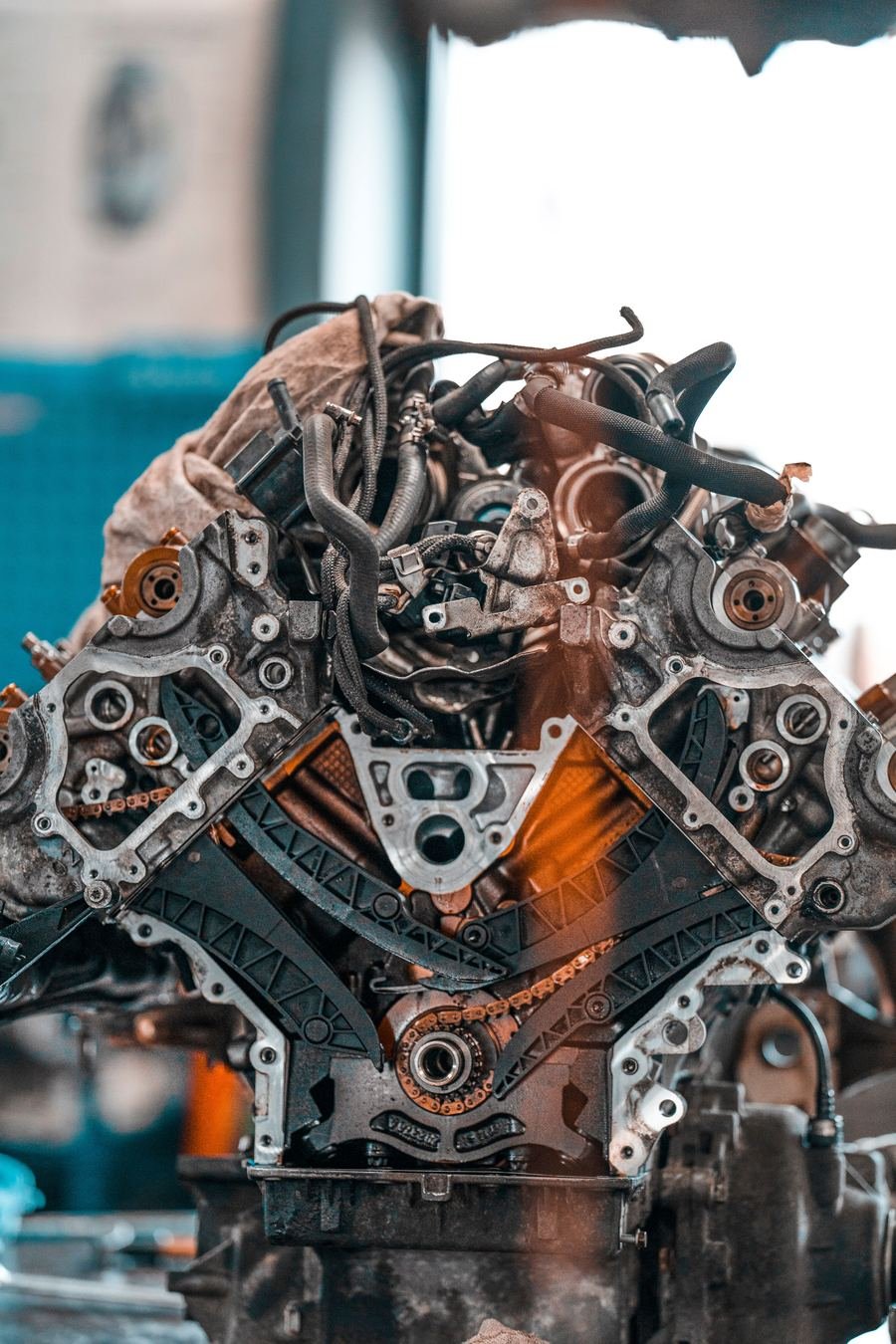 A stripped-down V8 engine on a stand in a workshop, mid-build